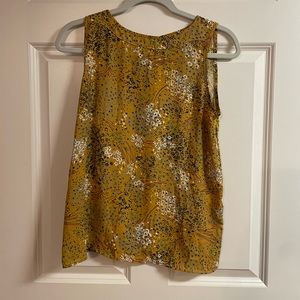 Gold floral sleeveless top.